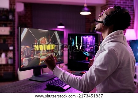 Gaming vlogger winning action video games tournament on live stream, celebrating online gameplay championship win on pc. Modern player streaming rpg esport competition on internet. Royalty-Free Stock Photo #2173451837