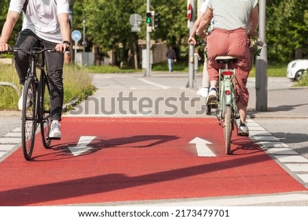 Bikes on Bicycle Path. Ride a bicycle. Cyclists on Red Bike lane on Sity Street. Traffic, city transport and people concept  Royalty-Free Stock Photo #2173479701