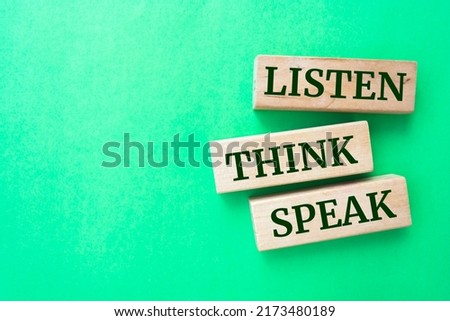 listen, think, speak words on wooden blocks on green background.	- communication concept