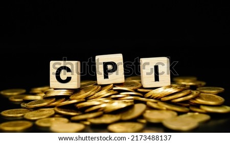 CPI, Stacks of gold coins with the letters CPI (Consumer Price Index) on a wooden cube. Business concept. Royalty-Free Stock Photo #2173488137