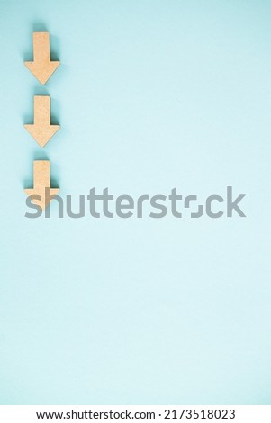 Wooden arrows point on blue background. Space for your text