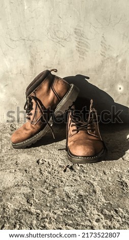 a pair of yellow boots on a white background