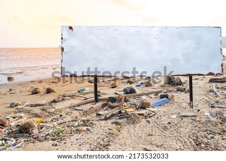 Blank sign board on dirty beach in Thailand, garbage from the sea on the beach, environment problem concept, outdoor day light, tourism