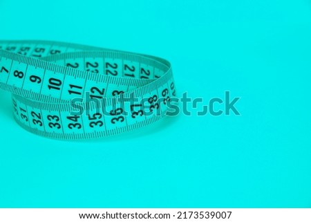 Blue tape measure diet concept on background with copyspace