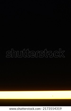 black background photo from shooting yellow light bulbs at night by keeping the lamp horizontal bottom of the picture