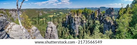 Panoramic over monumental Bastei sandstone pillars, rock formation and stacks surrounded by ancient forests at Kurort Rathen village in the national park Saxon Switzerland by Dresden, Saxony, Germany Royalty-Free Stock Photo #2173566549