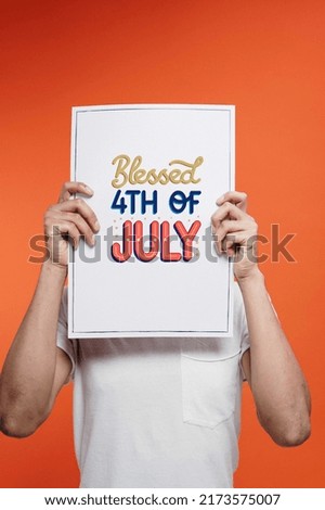 Man holding a paper with text Blessed 4th of July on color background. Happy Independence Day, the 4th of July national holiday.