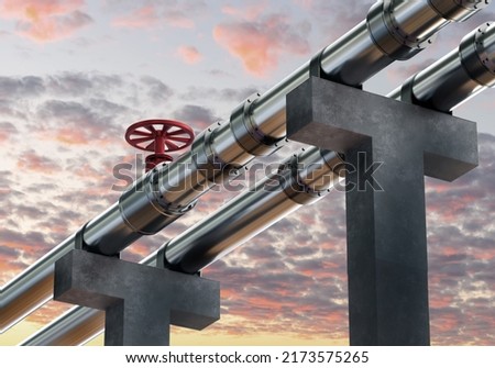 Concrete supports with pipes. Two steel pipes on background of sky. Pipes for transportation of oil products. Oil pipeline under clouds. Pipeline for import of fuel. Petroleum pipeline.  Royalty-Free Stock Photo #2173575265