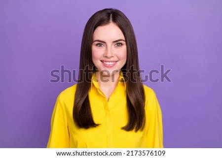 Portrait of attractive cheerful brunette girl wearing bright shirt isolated over vivid violet purple color background