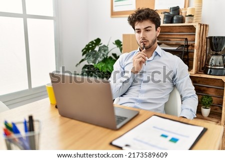 Young hispanic businessman concentrate working at the office.