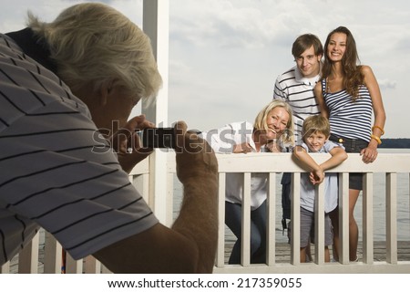Senior man taking family portrait