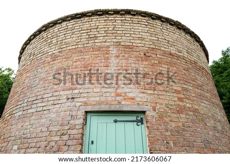 Vertical aspect view of a medieval round house turned into a Dovecote. The curved design is clearly evident.