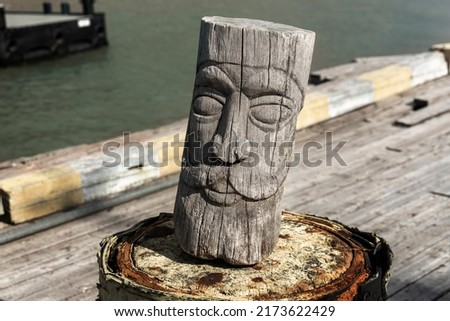 Close-view of carved wooden statue figure outdoors, Odin Viking god, Norse mythology. Pyramiden, Spitzbergen, Svalbard. Royalty-Free Stock Photo #2173622429