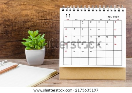 The November 2022 desk calendar on wooden table. Royalty-Free Stock Photo #2173633197