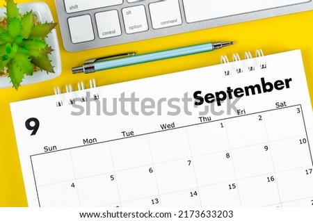 The September 2022 desk calendar with pen and keyboard computer on yellow background. Royalty-Free Stock Photo #2173633203