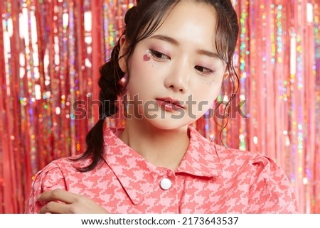 Beauty portrait of a young Asian woman with sticker makeup on glittery background Royalty-Free Stock Photo #2173643537