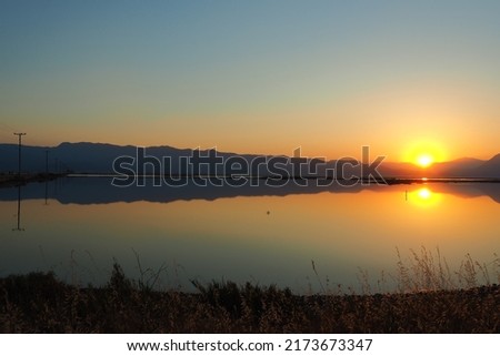 View of sunrise seen from Messolonghi, in western Greece, with the lagoon in the foreground, a Ramsar site protected by the convention on wetlands.