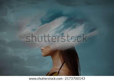 Woman head hidden by soft cloud on blue background, mental health, brain fog Royalty-Free Stock Photo #2173700143