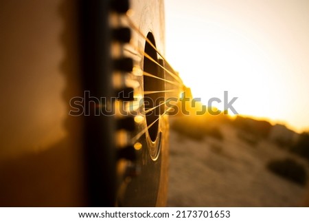 Guitar during the sunset.Playing guitar with some friends during the golden hour in the nature,just an hour before the nightfall. Royalty-Free Stock Photo #2173701653