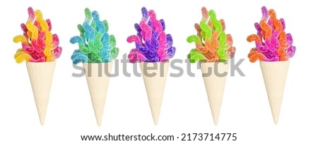 Group of waffle cones with jelly worms isolated on white background. Creative summer dessert.