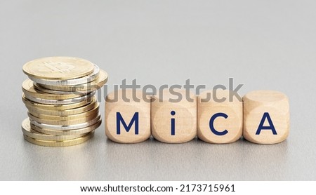 MiCA or Markets in Crypto Assets concept. Stacked cryptocurrency coins and wooden blocks with text. Copy space Royalty-Free Stock Photo #2173715961