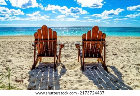 Two beach chairs on a sandy beach. Sandy beach scene. Two chairs on beach resort. Chairs on the beach Royalty-Free Stock Photo #2173724437