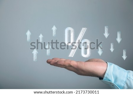 Icon of percentage and up and down arrows from web. Man holding in his hand