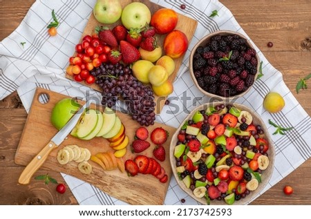 
healthy mixed fruit salad (Blackberry, banana, peach, nectarine, strawberry, apple, apricot, grape, min) on a crockery bowl, a heap of summer fruits concept, healthy vitamins. organic. Royalty-Free Stock Photo #2173742593