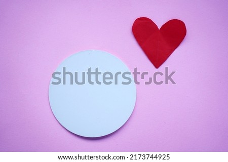 Blank white circle paper with red love heart shape on purple background. Valentines Day, anniversary and any cards concept. Copy space for your text design.