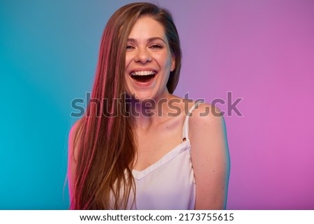 Happy woman face portrait with neon lights colors effect. Smiling girl mouth open isolated on neon multicolored background
