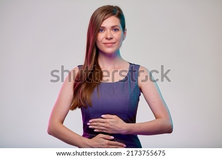 Smiling woman with hands on stomach, isolated portrait. photo with color filter.