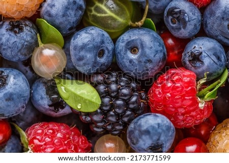 Water drops on ripe sweet blueberry.Vegan and vegetarian concept. Macro texture of blueberry berries.Cranberry in water.Juicy bright cherry and sweet cherry in water,