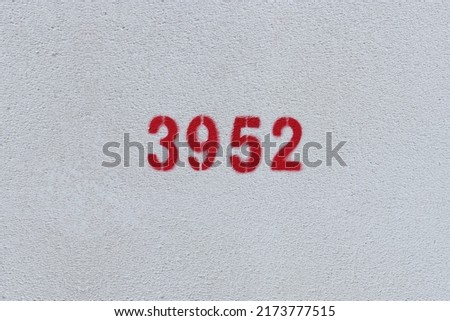 Red Number 3952 on the white wall. Spray paint.
