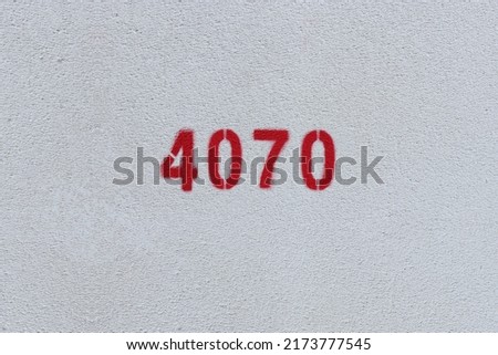Red Number 4070 on the white wall. Spray paint.
