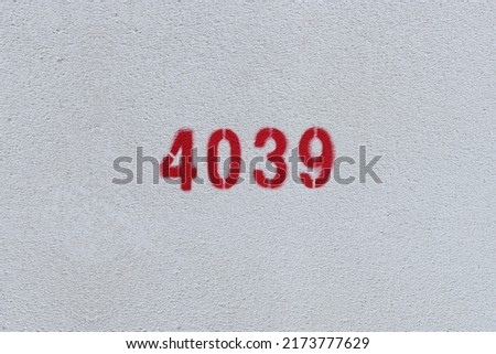Red Number 4039 on the white wall. Spray paint.
