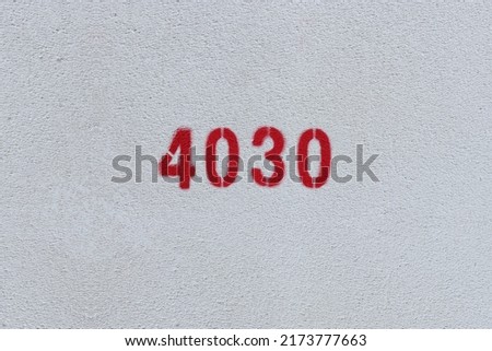 Red Number 4030 on the white wall. Spray paint.
