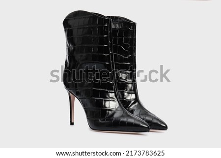 Black women's glossy leather high heel ankle boots in crocodile skin isolated on white background. Female fashion classic spring autumn shoes. Blank casual classic footwear with Pointy Toe. Mock up Royalty-Free Stock Photo #2173783625