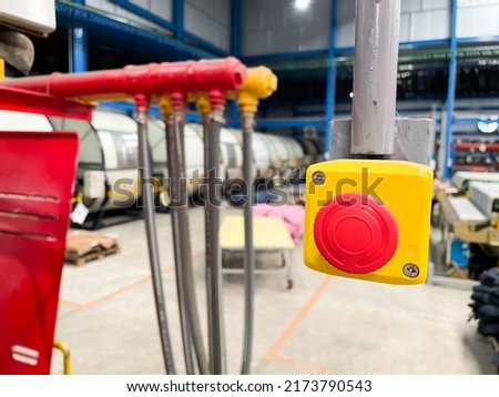 Stop Red Button and the Hand of Worker About to Press it. emergency stop button. Big Red emergency button or stop button for manual pressing. Royalty-Free Stock Photo #2173790543