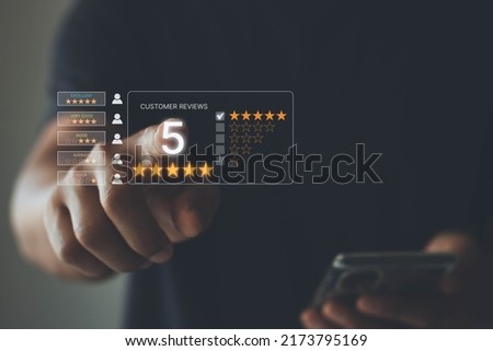 Customer review satisfaction feedback survey concept, User give good rating by five star to service experience on online application, Customer service evaluation to reputation ranking of business. Royalty-Free Stock Photo #2173795169