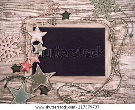 Black chalkboard with various winter decorations, text space 
