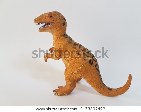 Plastic Allosaurus dinosaur toys isolated on white background