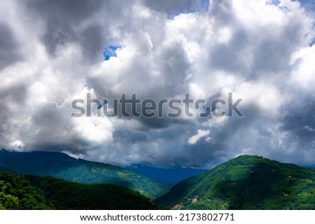 Majestic clouds and verdant mountains.