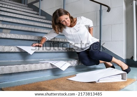 Fall And Fall Injury Accident At Workplace. Woman Fell Down Stairs Royalty-Free Stock Photo #2173813485