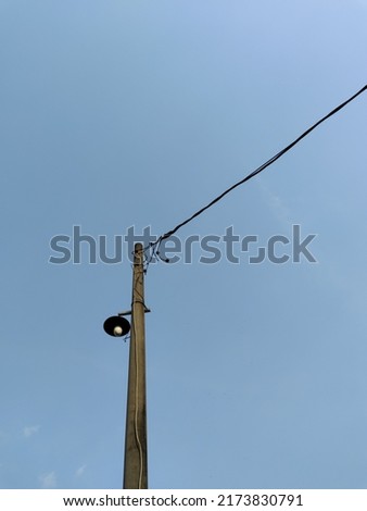 Isolated lamp post electricity industry with blue sky background. Negative space 