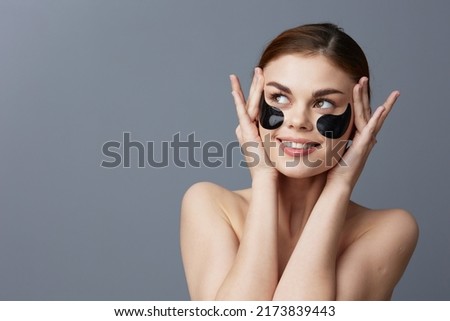woman eye patches on face bare shoulders skin care isolated background