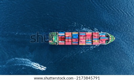 Aerial top view of cargo ship carrying container and running with Pilot Boat for export goods from cargo yard port to custom ocean concept technology transportation logistic trader blobal  forwarder  Royalty-Free Stock Photo #2173845791