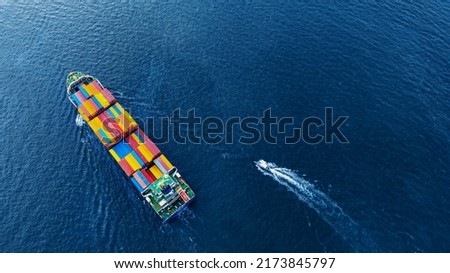 Aerial top view of cargo ship carrying container and running with Pilot Boat for export goods from cargo yard port to custom ocean concept technology transportation logistic trader blobal  forwarder