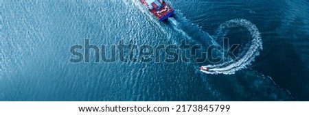 Pilot boat turn behind stern of Vessel Cargo container Ship in the ocean sea concept logistic transportation team support partner working  forwarder mast