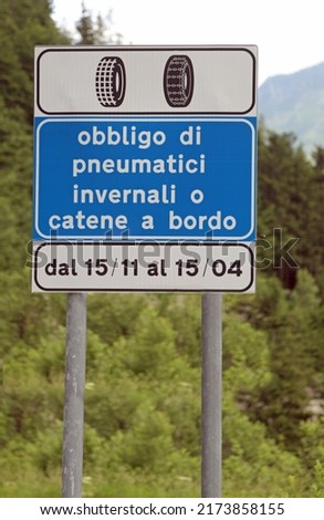 road sign with the writing in Italian which means Obligation of winter tires or snow chains on board from November to April