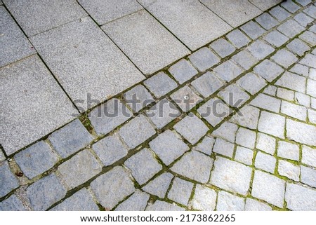 Urban background of pavement and cobble stones in a street.